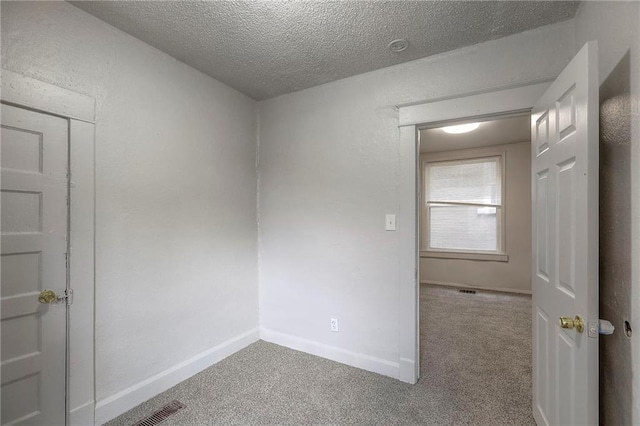 336 N 16th St, Kansas City, KS 66102 - carpeted empty room with a textured ceiling and baseboards