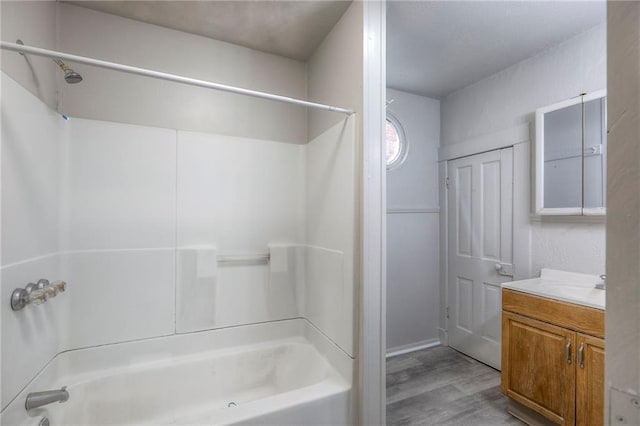 336 N 16th St, Kansas City, KS 66102 - full bath with vanity, washtub / shower combination, and wood finished floors