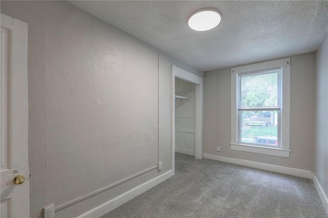 336 N 16th St, Kansas City, KS 66102 - unfurnished bedroom with a textured ceiling, carpet, a closet, and a textured wall