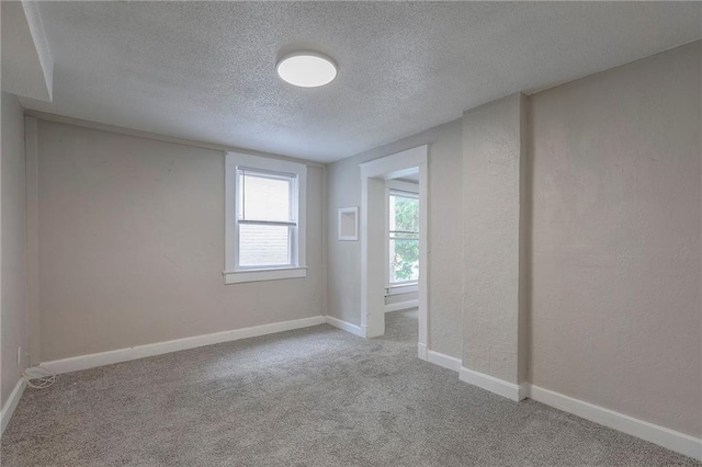 336 N 16th St, Kansas City, KS 66102 - carpeted empty room with a textured ceiling and a textured wall