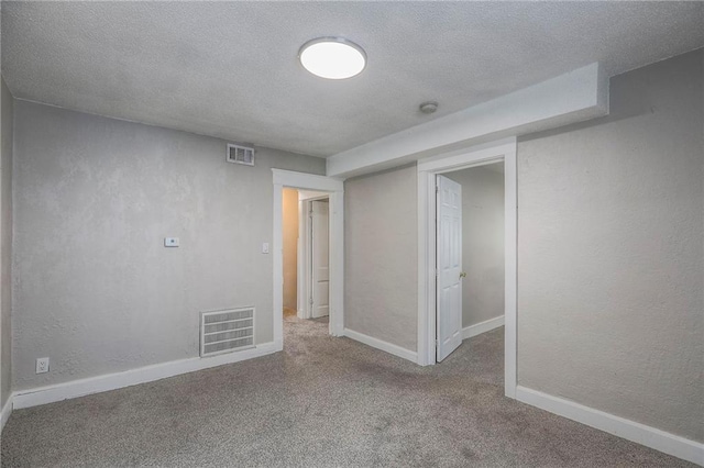 336 N 16th St, Kansas City, KS 66102 - below grade area with carpet flooring, a textured ceiling, and a textured wall