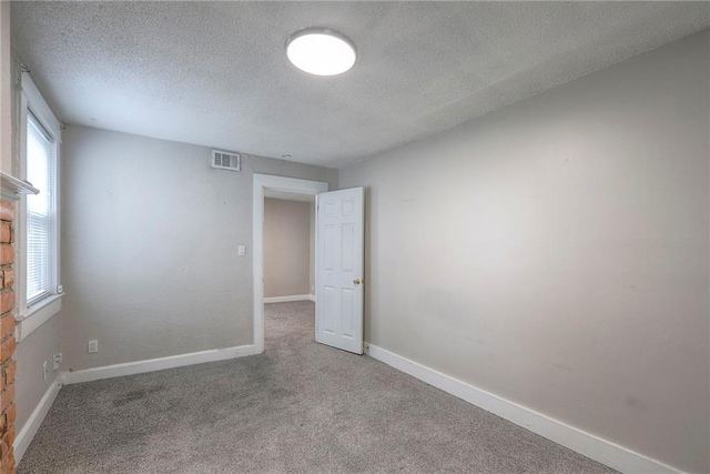 336 N 16th St, Kansas City, KS 66102 - carpeted empty room featuring a textured ceiling and baseboards