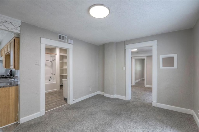 336 N 16th St, Kansas City, KS 66102 - unfurnished living room with carpet, a textured ceiling, and a textured wall