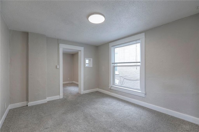 336 N 16th St, Kansas City, KS 66102 - unfurnished room with a textured ceiling, carpet, and a textured wall