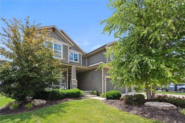 24631 W 126th St, Olathe, KS 66061 - craftsman house featuring covered porch, a front lawn, and stone siding