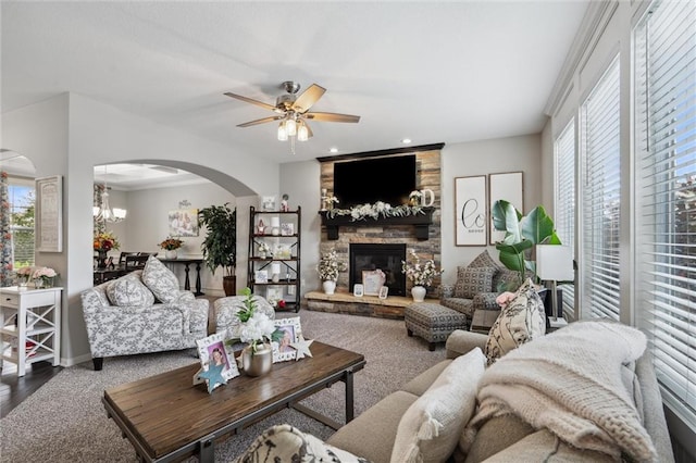 24631 W 126th St, Olathe, KS 66061 - living room featuring arched walkways, a stone fireplace, ceiling fan, and recessed lighting