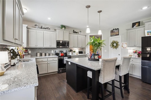 24631 W 126th St, Olathe, KS 66061 - kitchen with stainless steel microwave, electric stove, freestanding refrigerator, backsplash, and recessed lighting
