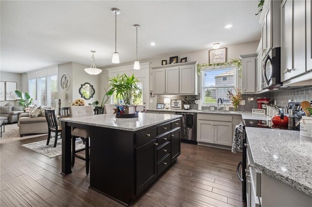 24631 W 126th St, Olathe, KS 66061 - kitchen with stainless steel appliances, a breakfast bar, backsplash, open floor plan, and recessed lighting
