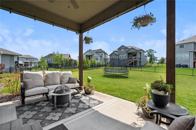 24631 W 126th St, Olathe, KS 66061 - fenced backyard featuring a trampoline, a residential view, a patio area, and an outdoor living space with a fire pit