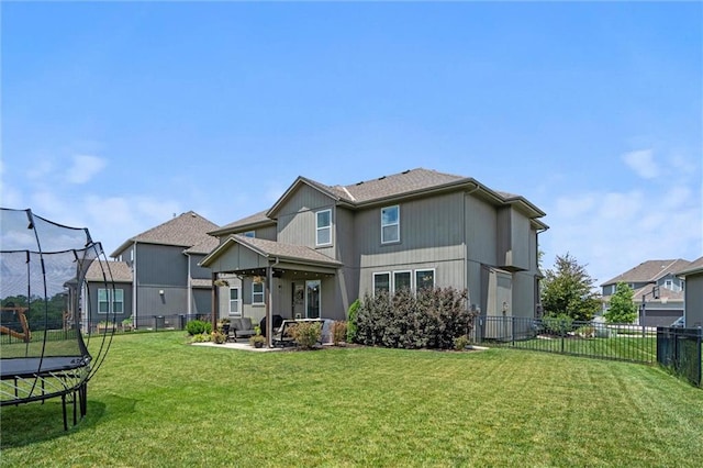 24631 W 126th St, Olathe, KS 66061 - rear view of house with a trampoline, a patio, and a fenced backyard