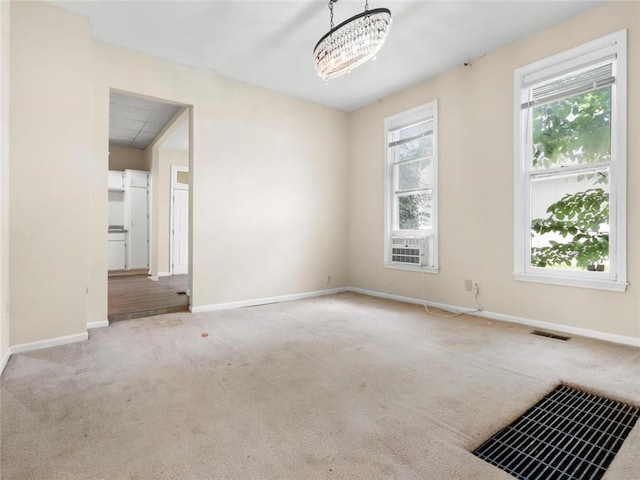 2703 Olive St, Saint Joseph, MO 64507 - carpeted empty room with a chandelier and cooling unit