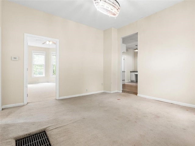 2703 Olive St, Saint Joseph, MO 64507 - carpeted empty room with baseboards and a chandelier