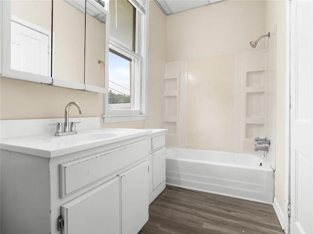 2703 Olive St, Saint Joseph, MO 64507 - bathroom featuring vanity,  shower combination, and wood finished floors