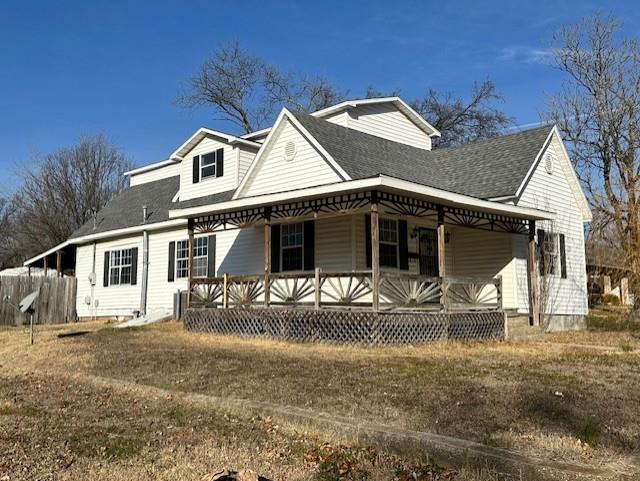 526 S W St, Nevada, MO 64772 - view of front of home featuring covered porch and roof with shingles