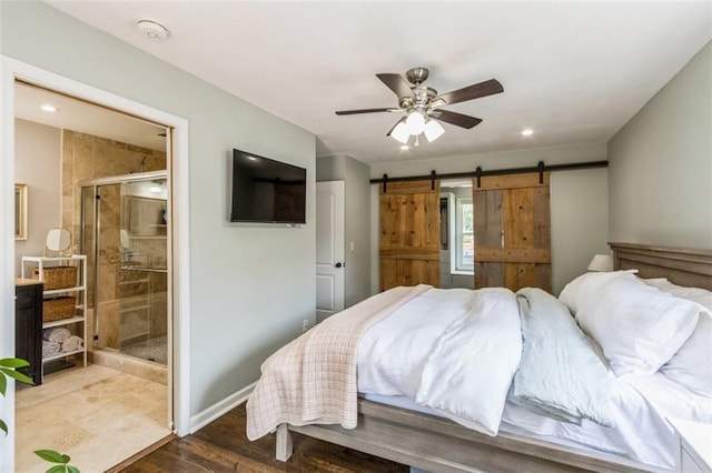 7718 Pawnee St, Prairie Village, KS 66208 - bedroom with a barn door, wood finished floors, recessed lighting, ensuite bathroom, and ceiling fan