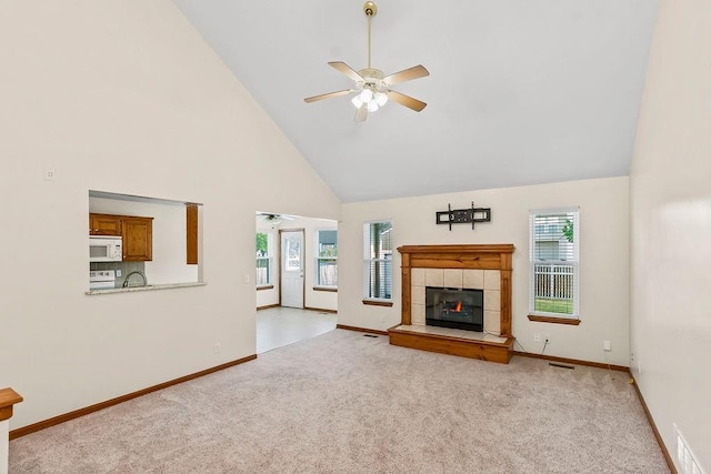 321 W Mockingbird St, Gardner, KS 66030 - unfurnished living room featuring high vaulted ceiling, ceiling fan, light carpet, and healthy amount of natural light
