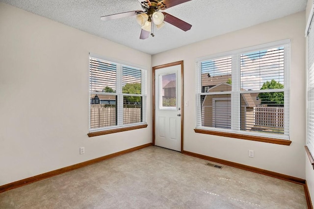 321 W Mockingbird St, Gardner, KS 66030 - empty room featuring healthy amount of natural light, a textured ceiling, and ceiling fan