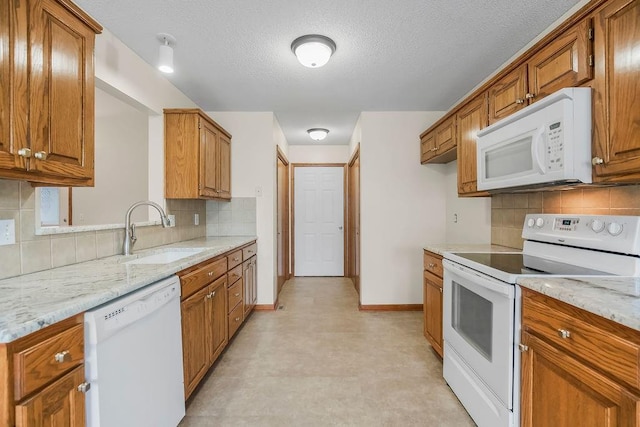 321 W Mockingbird St, Gardner, KS 66030 - kitchen featuring white appliances, brown cabinets, light floors, backsplash, and a textured ceiling