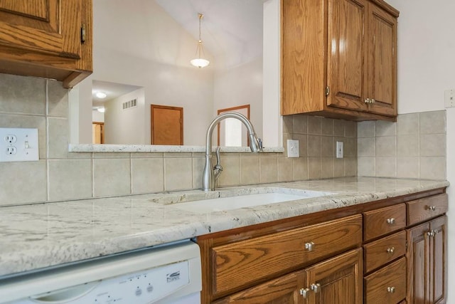 321 W Mockingbird St, Gardner, KS 66030 - kitchen with dishwasher, brown cabinets, decorative backsplash, and lofted ceiling