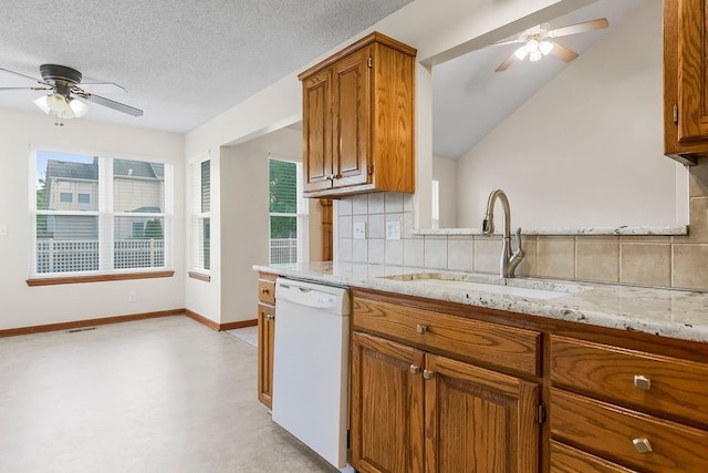 321 W Mockingbird St, Gardner, KS 66030 - kitchen with dishwasher, a ceiling fan, backsplash, brown cabinetry, and light stone countertops