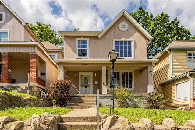 3620 Smart Ave, Kansas City, MO 64124 - view of front of property featuring stucco siding and a porch