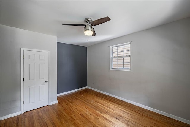 3620 Smart Ave, Kansas City, MO 64124 - unfurnished room featuring a ceiling fan and wood finished floors