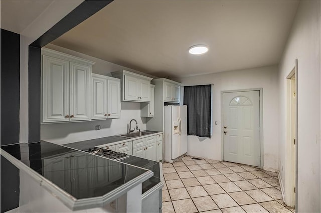 3620 Smart Ave, Kansas City, MO 64124 - kitchen with white refrigerator with ice dispenser, tile countertops, white cabinetry, and light tile patterned floors