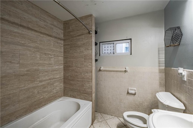 3620 Smart Ave, Kansas City, MO 64124 - full bathroom featuring tile walls, shower / bathtub combination, tile patterned flooring, and a wainscoted wall