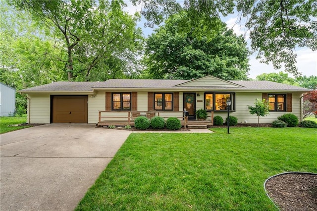 8039 Kessler St, Overland Park, KS 66204 - ranch-style home featuring covered porch, concrete driveway, an attached garage, and a front yard