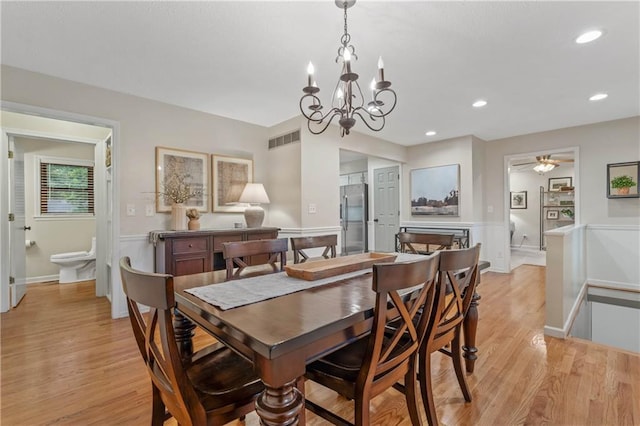 8039 Kessler St, Overland Park, KS 66204 - dining room featuring a wainscoted wall, light wood-style floors, a chandelier, a decorative wall, and recessed lighting