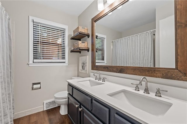 8039 Kessler St, Overland Park, KS 66204 - full bathroom featuring double vanity, wood finished floors, and a shower with shower curtain