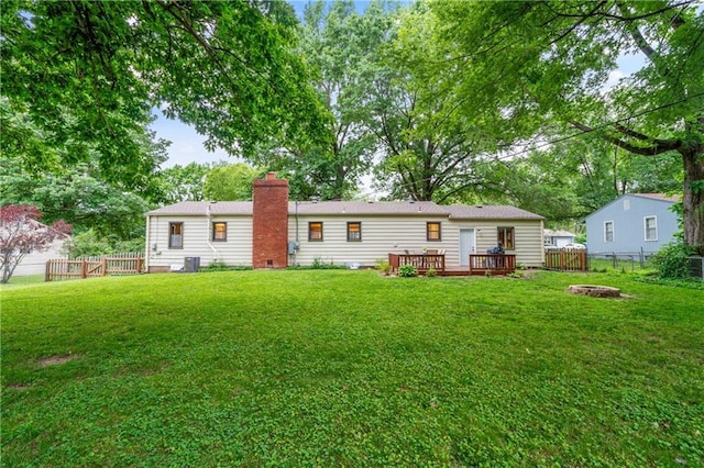 8039 Kessler St, Overland Park, KS 66204 - rear view of house with an outdoor fire pit, a fenced backyard, a chimney, and a wooden deck