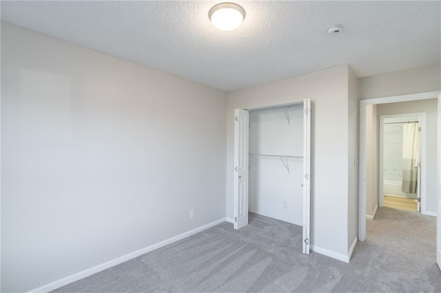 911 SE Hampton Ct, Lees Summit, MO 64063 - unfurnished bedroom with light carpet, a closet, and a textured ceiling