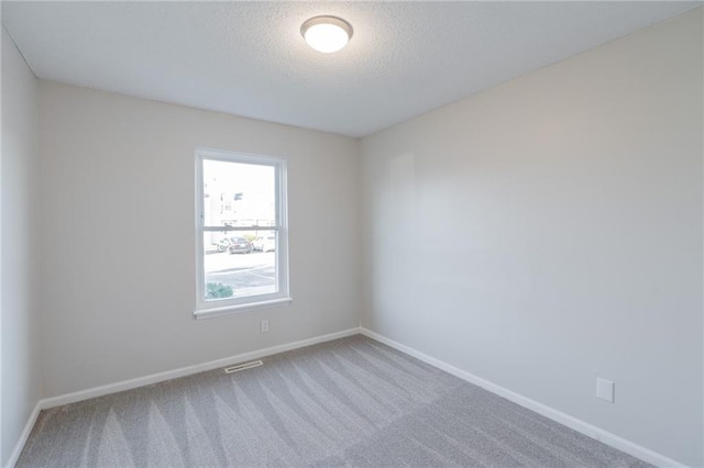 911 SE Hampton Ct, Lees Summit, MO 64063 - unfurnished room featuring carpet floors and a textured ceiling