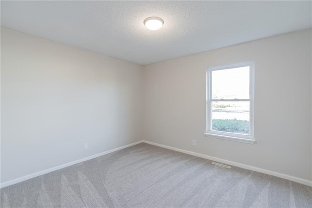 911 SE Hampton Ct, Lees Summit, MO 64063 - spare room featuring carpet floors and a textured ceiling