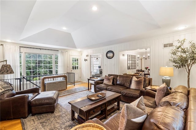 8315 Sagamore Rd, Leawood, KS 66206 - living area featuring light wood-type flooring, a chandelier, and a raised ceiling