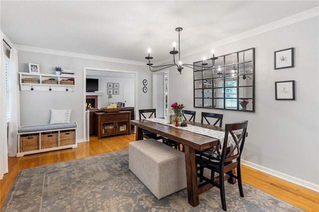 8315 Sagamore Rd, Leawood, KS 66206 - dining area with a chandelier, ornamental molding, and wood finished floors