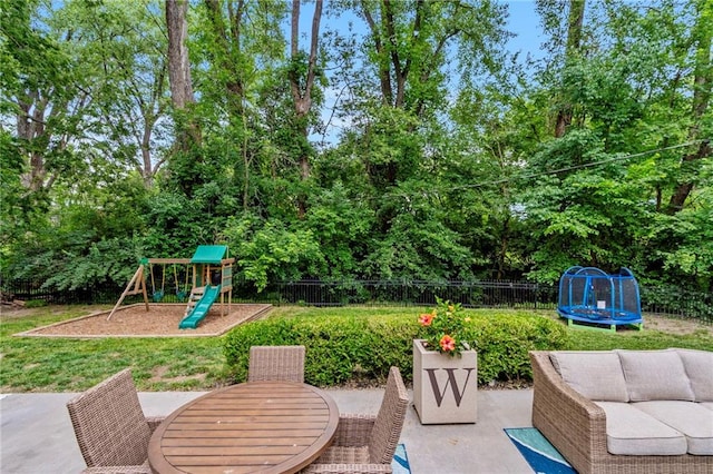 8315 Sagamore Rd, Leawood, KS 66206 - fenced backyard with a trampoline, a playground, a patio, outdoor lounge area, and view of scattered trees