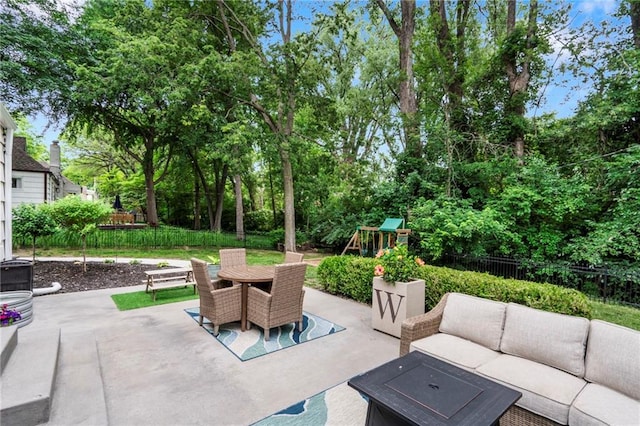 8315 Sagamore Rd, Leawood, KS 66206 - fenced backyard featuring an outdoor hangout area, a patio area, outdoor dining space, a playground, and view of wooded area