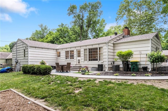 8315 Sagamore Rd, Leawood, KS 66206 - back of house with a chimney, a patio area, and a shingled roof