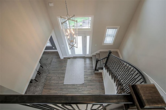 18421 Caenen St, Overland Park, KS 66013 - foyer entrance with a chandelier, a towering ceiling, stairs, and wood finished floors