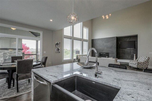 18421 Caenen St, Overland Park, KS 66013 - kitchen with stainless steel dishwasher, open floor plan, dark wood-type flooring, light stone counters, and recessed lighting