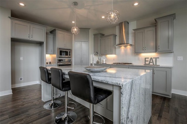 18421 Caenen St, Overland Park, KS 66013 - kitchen with wall chimney exhaust hood, gray cabinetry, stainless steel appliances, recessed lighting, and dark wood-style floors