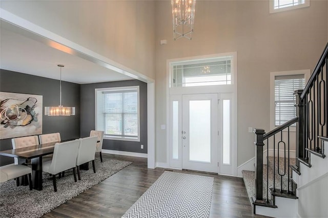 18421 Caenen St, Overland Park, KS 66013 - entryway featuring a chandelier, a towering ceiling, stairway, and wood finished floors