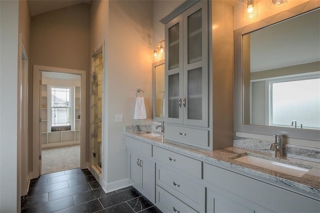18421 Caenen St, Overland Park, KS 66013 - full bathroom with double vanity, a stall shower, and tile patterned floors