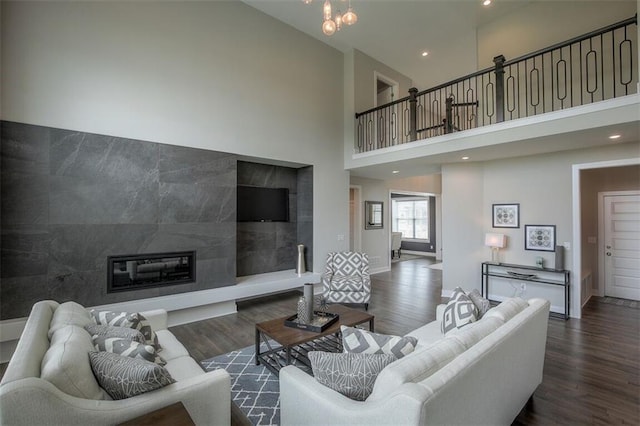 18421 Caenen St, Overland Park, KS 66013 - living area with a towering ceiling, wood finished floors, a fireplace, and recessed lighting