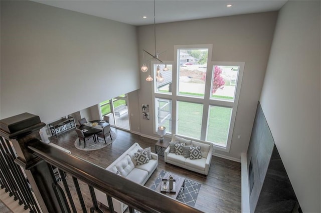 18421 Caenen St, Overland Park, KS 66013 - living area with wood finished floors, a chandelier, a high ceiling, and recessed lighting