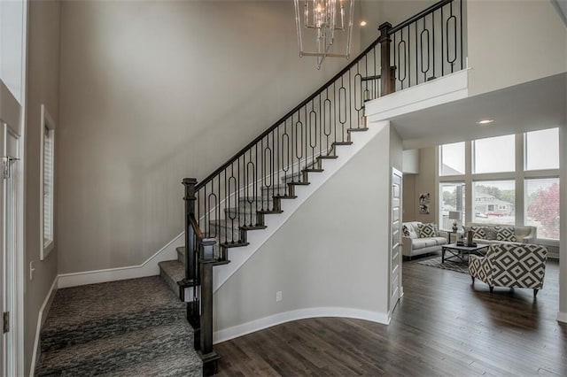 18421 Caenen St, Overland Park, KS 66013 - staircase with a towering ceiling, wood finished floors, and a chandelier