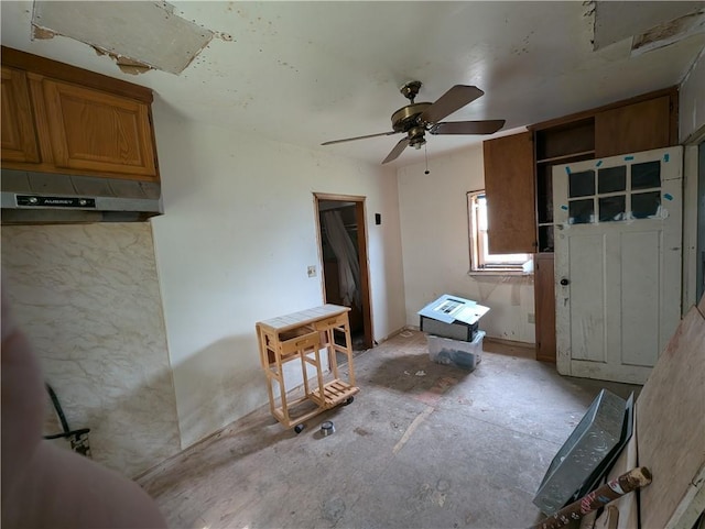 907 Scott Ave, Kansas City, KS 66105 - kitchen featuring a ceiling fan and brown cabinetry