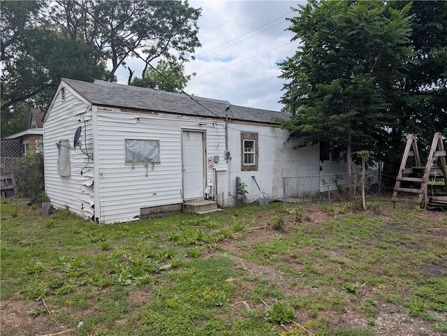 907 Scott Ave, Kansas City, KS 66105 - rear view of property with entry steps and a shingled roof